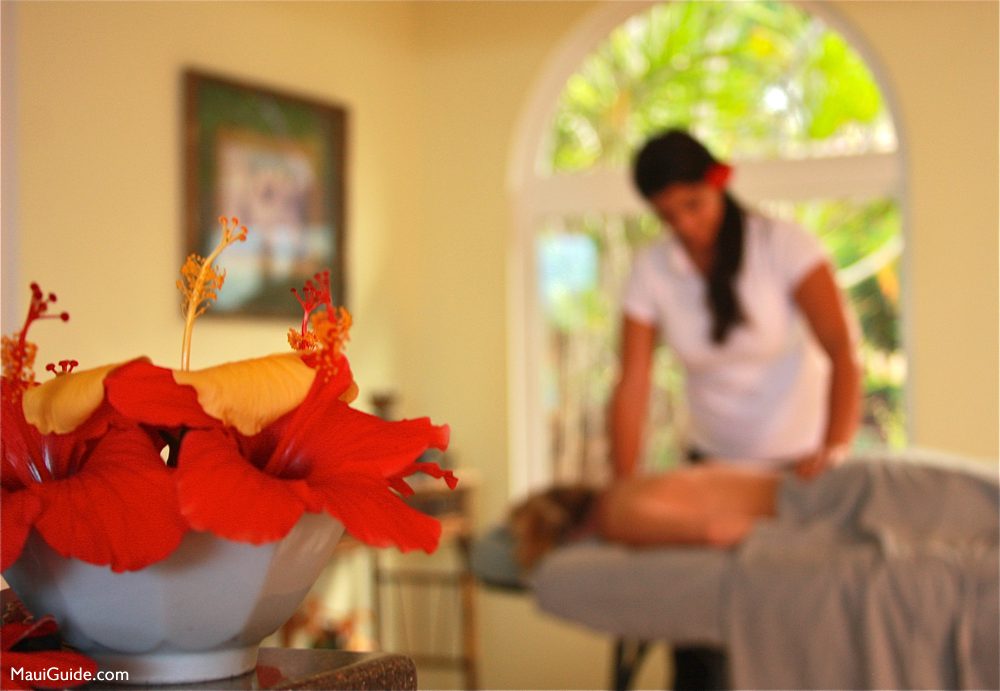 Hibiscus flowers with a Maui massage therapist in the background