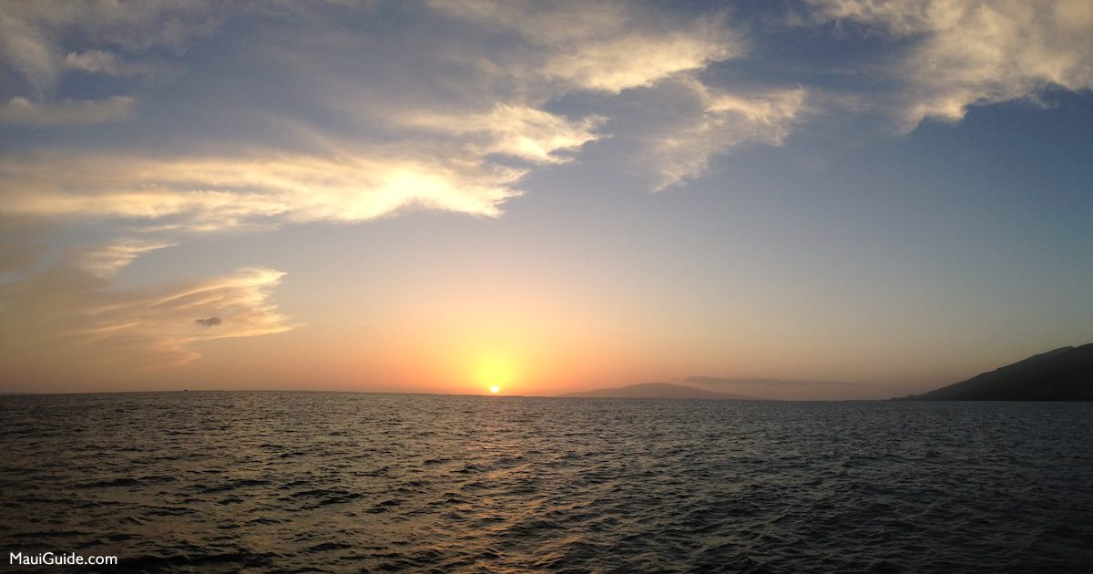 Sun setting over the ocean from a Maui cruise
