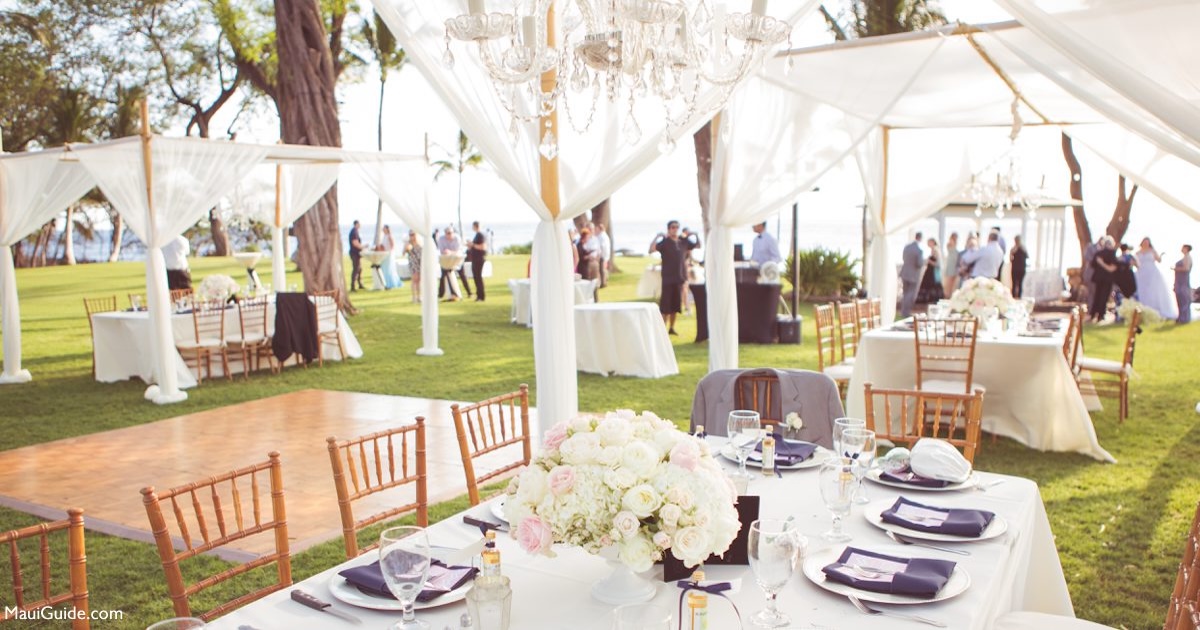 Maui wedding reception tables with white drapes and ocean views