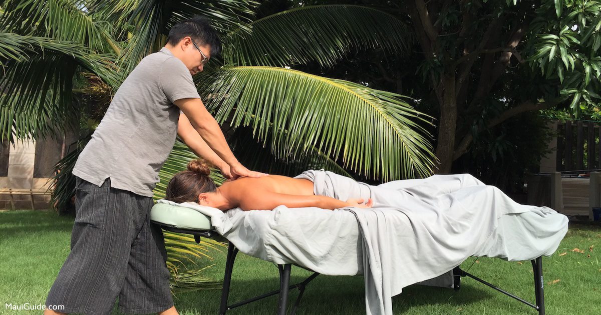 Outdoor massage beneath palm trees on Maui