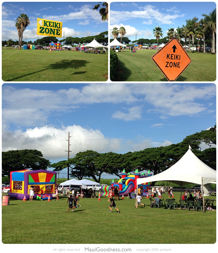 Keiki zone signs, inflatable slides and play areas at the 2015 Waikapū festival